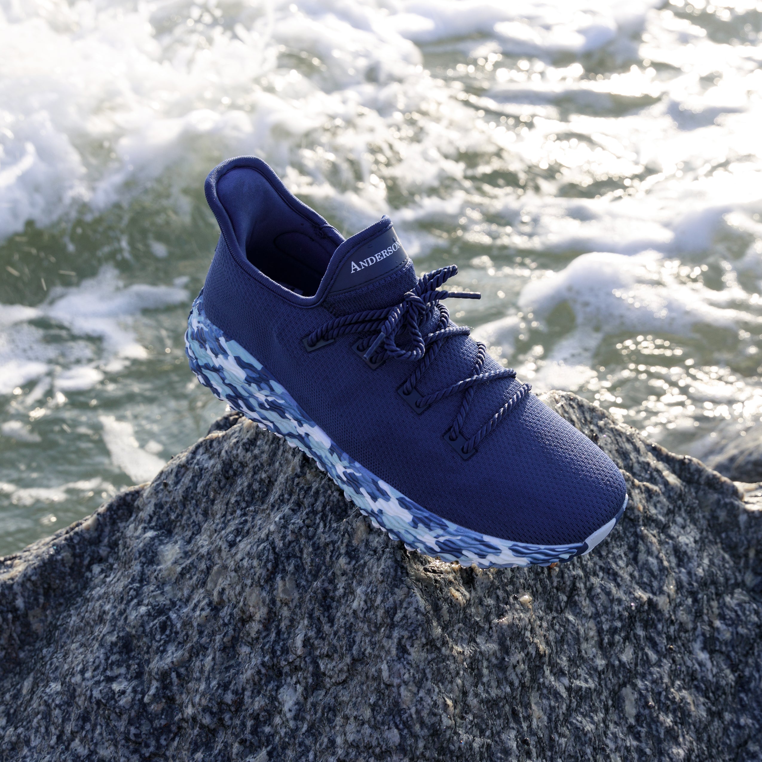 Blue Athletic Performance Shoe. AO Wave1. Blue Camo Golf Shoe on the beach. Made with high-quality materials.