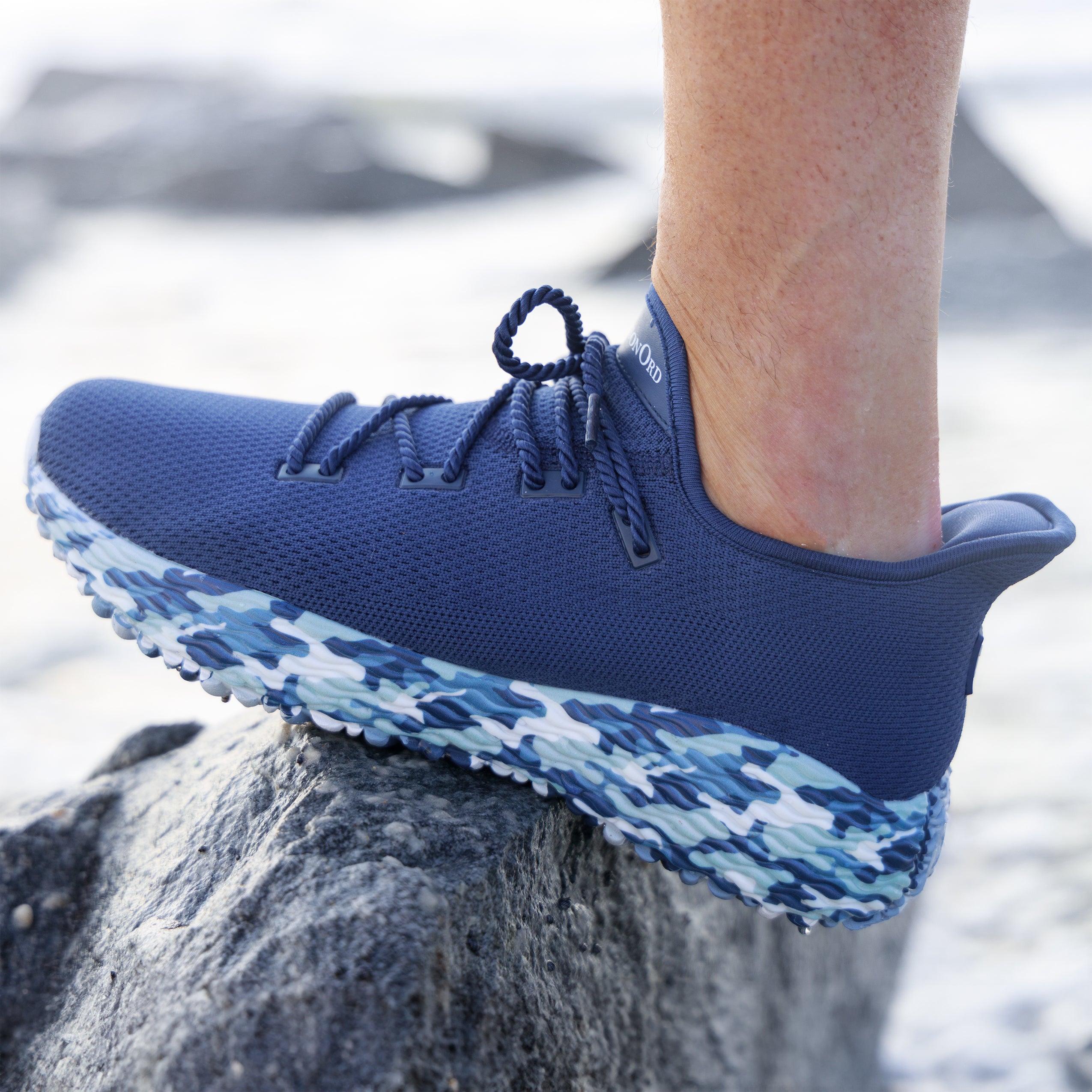 Blue Camo AO Wave 1 on the beach. Perfect shoe for running, best shoe for pickleball, and the ultimate golf shoe. Shoe made with breathable fabric and excellent support