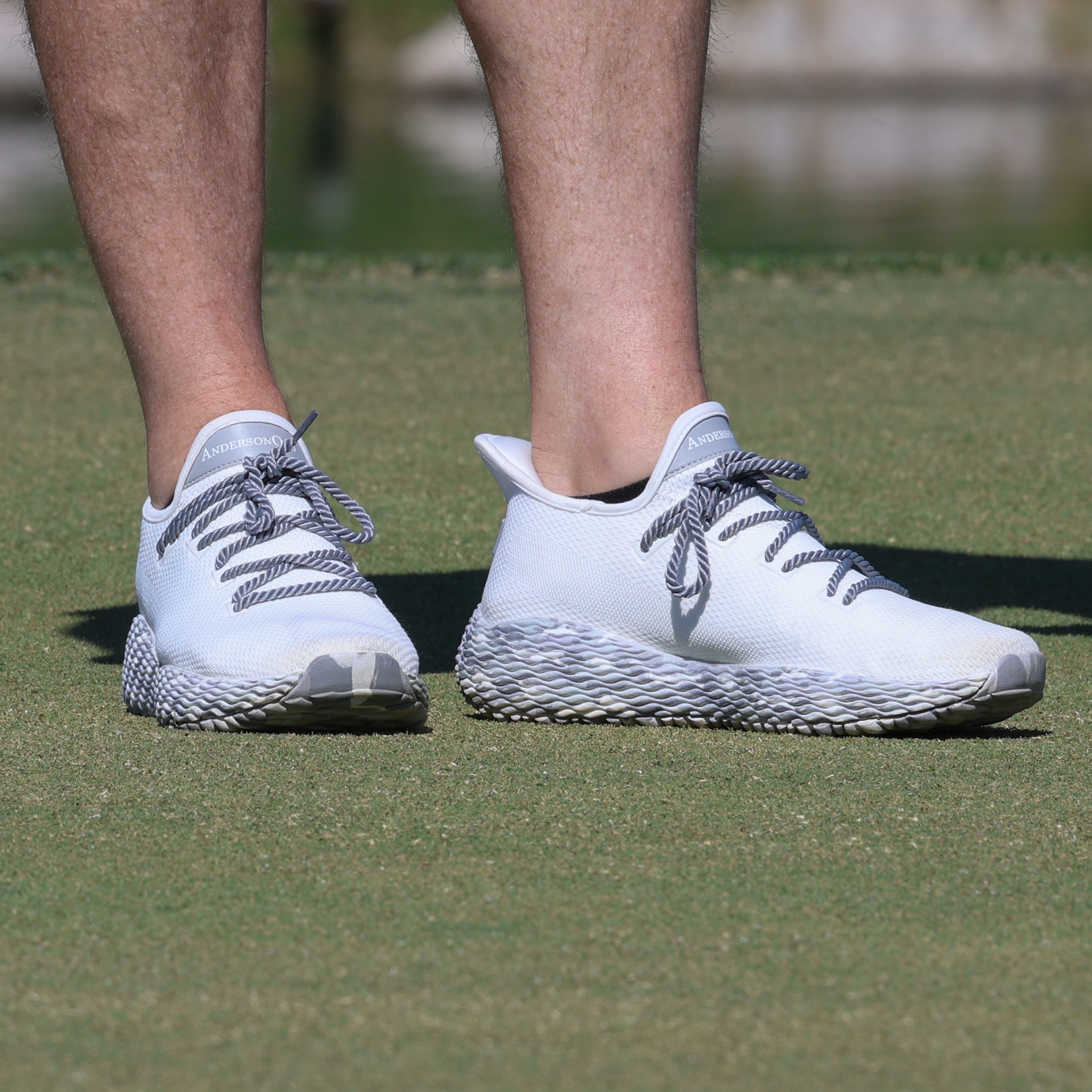 AO Wave 1, white performance golf shoes, great pickleball shoes, photographed on the golf course. Grey Camo pickleball shoes.