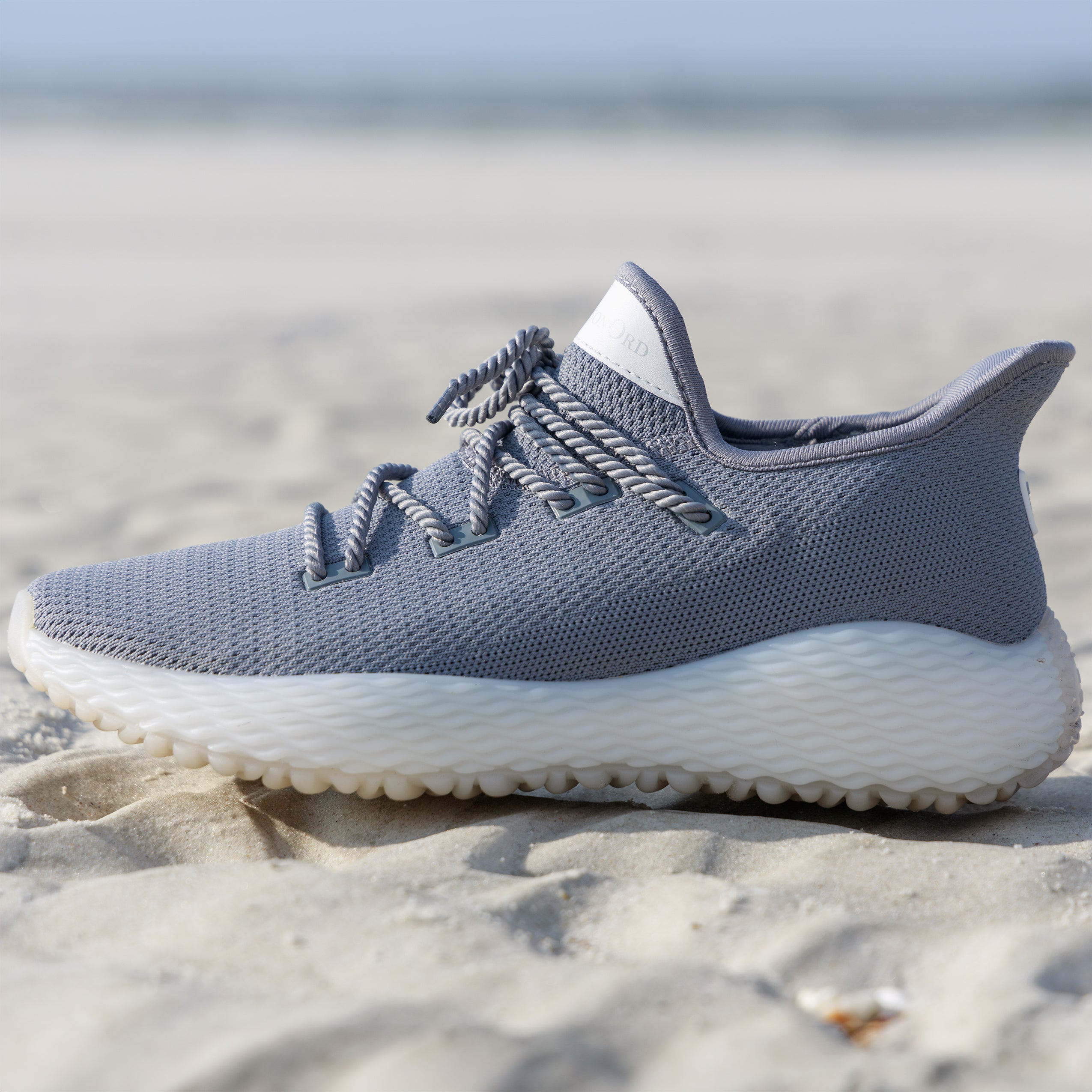 Grey Athletic Performance Shoe on sand. Perfect beach running shoe. Andersonord AO Wave1. Grey Golf Shoe