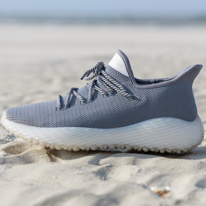 Grey Athletic Performance Shoe on sand. Perfect beach running shoe. Andersonord AO Wave1. Grey Golf Shoe