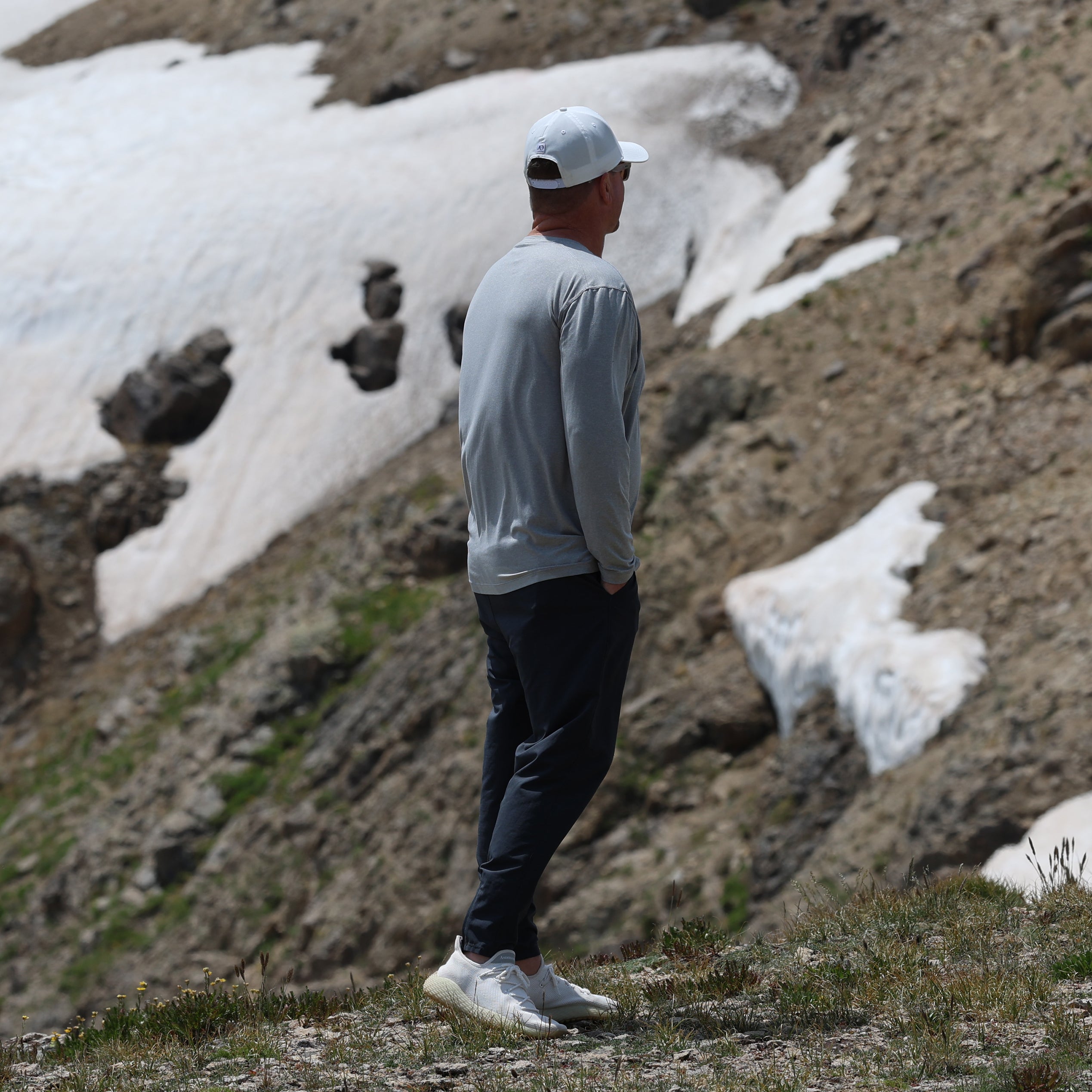 Man wearing white performance running shoes on a mountain